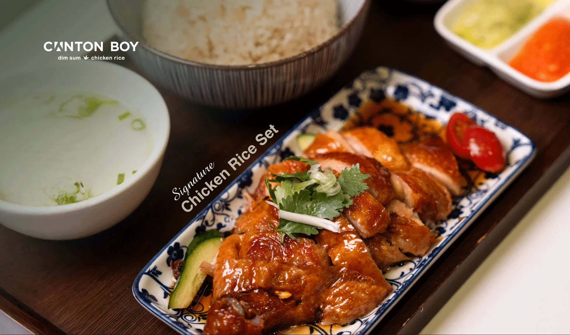 Menu page for Canton Boy showing our roasted chicken rice set with a close up of the roasted chicken in a blue and white chinese porcelain dish with a bowl of rice, soup, and a saucer with green and red chilli sauce